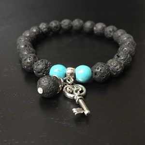 NATURAL LAVA STONE BEADED BRACELET W/ANTIQUE SILVER CHARM